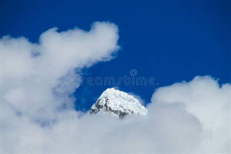 Mountain Snow Capped Peak Through The Clouds Stock Photo Image Of