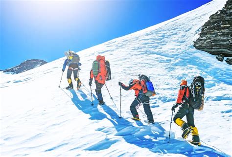 Team Of Four Alpinists Climbing A Mountain Stock Photo Image Of