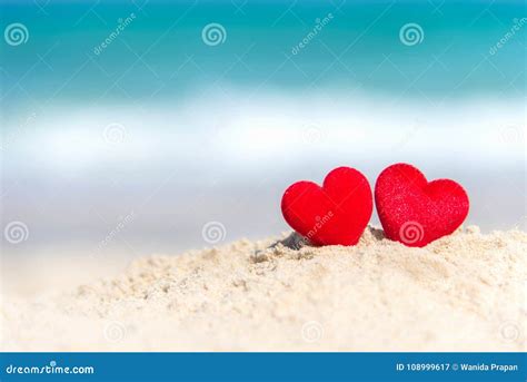 Valentine Concept Two Red Hearts On The Sand Summer Beach Stock Image