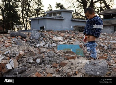 A Babe Peeing In A Neighbourhood Hutong Partially Destroyed And Marked For Demolition Beijing