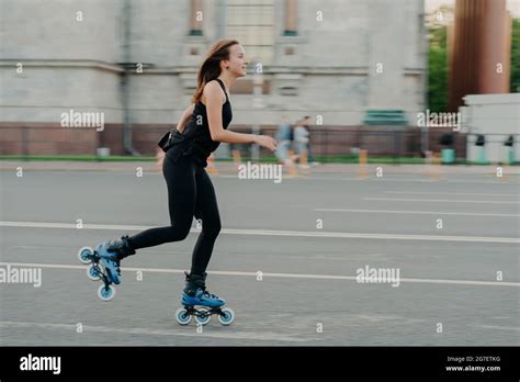 Summer Rollerblading And Fitness Concept Fit Young Dark Haired Woman