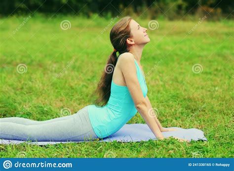 Fitness Woman Doing Yoga Exercises Back Stretching On A Mat On The