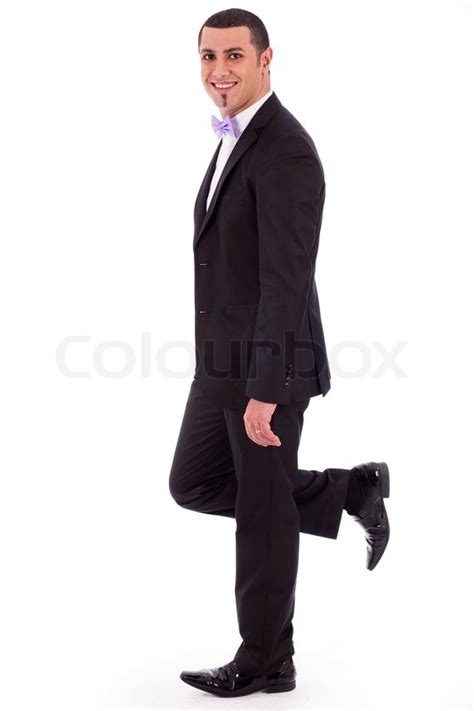 Full Length Of A Business Man Leaning Against The Wall On A White