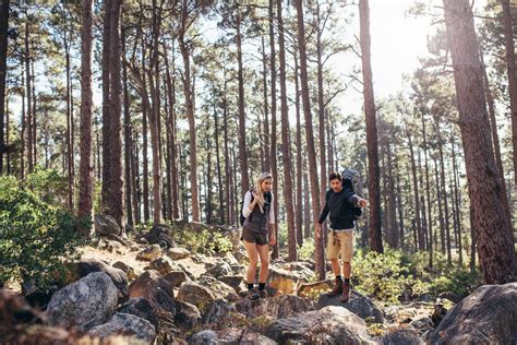Hiking Couple Walking On Rocks In Forest Wearing Backpacks Jacob Lund Photography Store