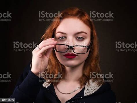 Beautiful Nerd Girl Or Young Woman Looking Over Eyeglasses Stock Photo