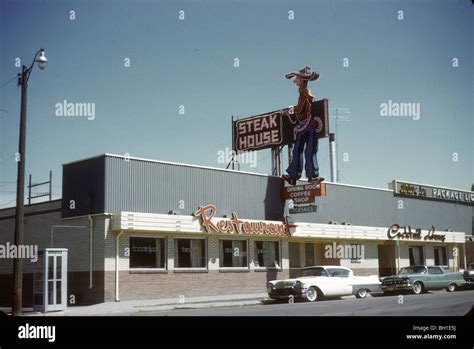 Steakhouse restaurant and cars in Wyoming during 1959 or 1960. Street