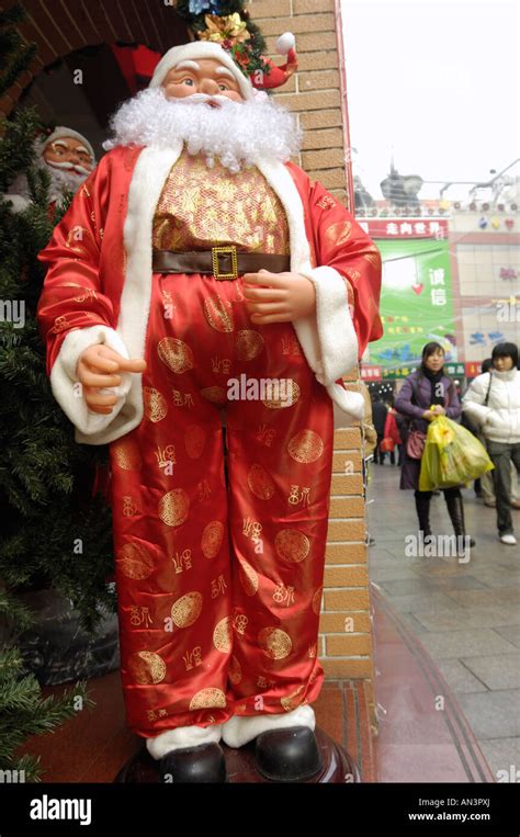 Santa Claus With Chinese Traditional Clothes On Sale In A Market In