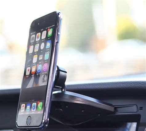 An Iphone Is Sitting In The Dashboard Of A Car With Its Holder Attached