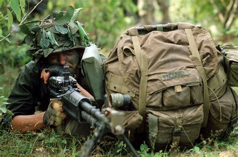 A Us Marine Aims An M60 Machine Gun While On Combat Patrol During Cobra