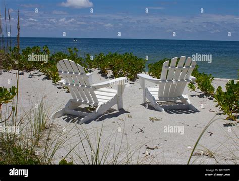 Two Adirondack Chairs On A Beach Stock Photo Alamy