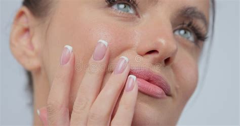 Close Up Beauty Portrait Of Young Woman Softly Touches Her Chin With A