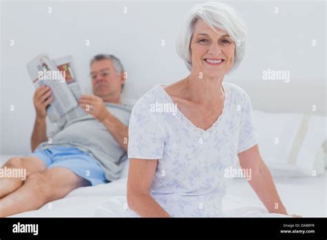 Mature Woman Sitting On Bed Stock Photo Alamy