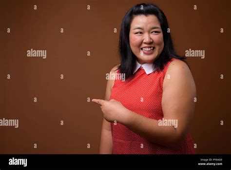 Beautiful Overweight Woman Laughing And Pointing Finger To Copy Space