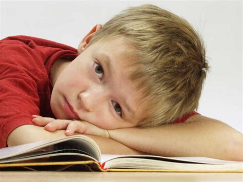 Bored Boy Reading School Book Stock Photo