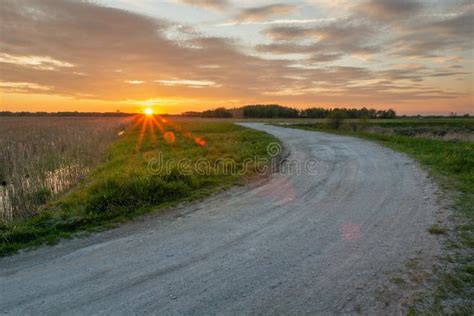 Gravel Road Through The Meadow Horizon And Sky After Sunset Stock