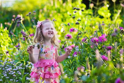 Little Girl In Flower Garden — Stock Photo © Famveldman 82031146
