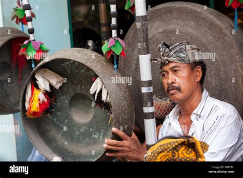 Bali Indonesia Balinese Hindu Playing A Gong In A Village Gamelan
