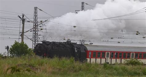 Historic Steam Locomotive With Passenger Wagons On Rail Tracks Stock