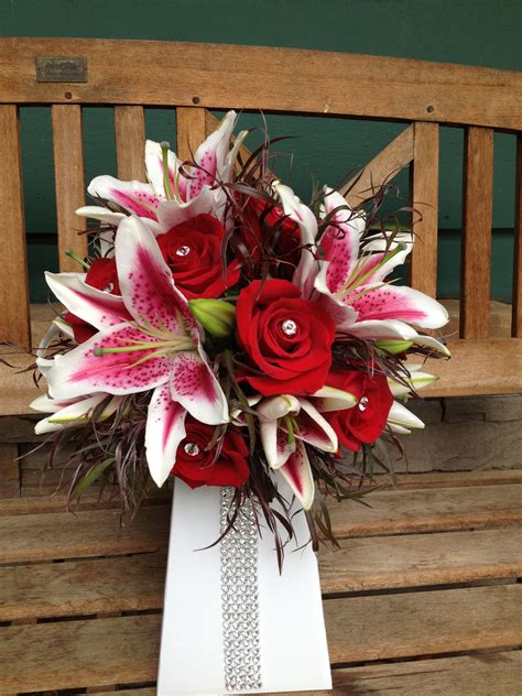 Red Roses And Stargazer Lilies Accented With Crystal Pins In The Roses