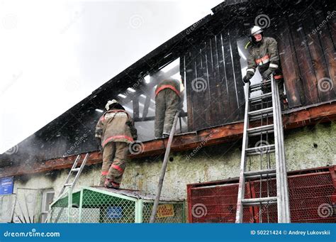 Firefighters Extinguish A Fire On The Roof Editorial Stock Image