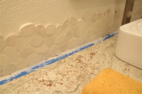Great selection of tile backsplashes for kitchens, bathrooms and bars. Grouting the live edge pebble tile backsplash ...