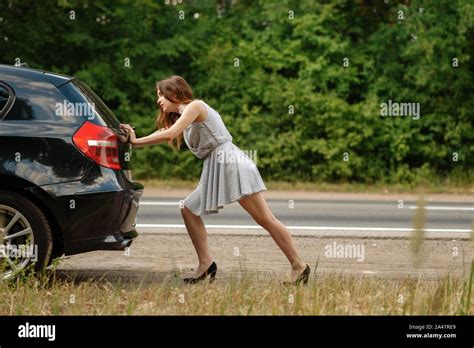 Woman Pushing Broken Car On Road Breakdown Stock Photo Alamy