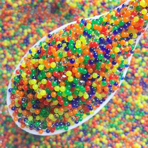 A Spoon Filled With Lots Of Colorful Beads