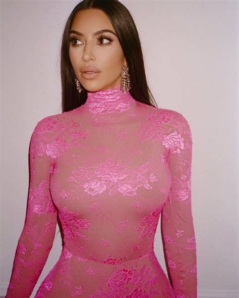 kim kardashian almost spills out of her tiny pink bikini in sexy pose