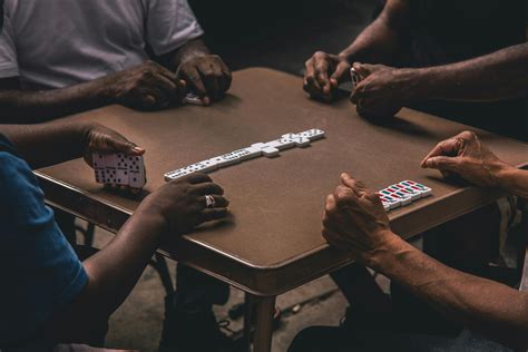 Four People Playing Dominoes · Free Stock Photo