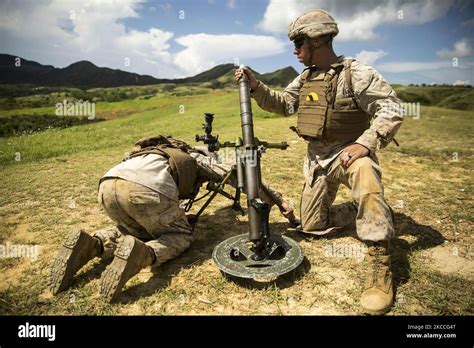 A Us Marine Loads A 60 Mm Mortar At Camp Hansen Okinawa Japan Stock