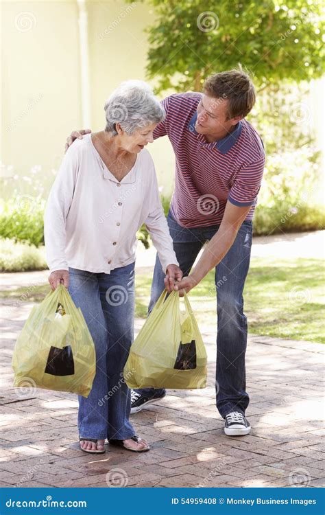 Man Helping Senior Woman With Shopping Stock Photo Image Of Grown