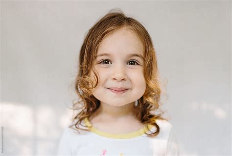 Adorable Young Girl With Big Cheeks Smiling At The Camera By Jakob