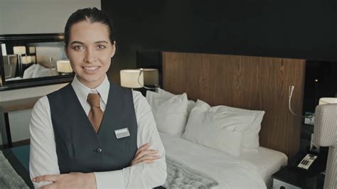 Medium Slowmo Portrait Of Attractive Young Female Hotel Manager Smiling To Camera Standing With