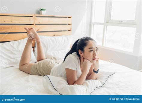Woman Is Lying On Bed And Seriously Watching Drama Tv Series Stock Photo Image Of Control