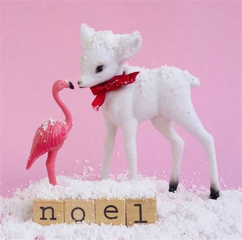 A Pink Flamingo Standing Next To A White Stuffed Animal On Top Of Snow