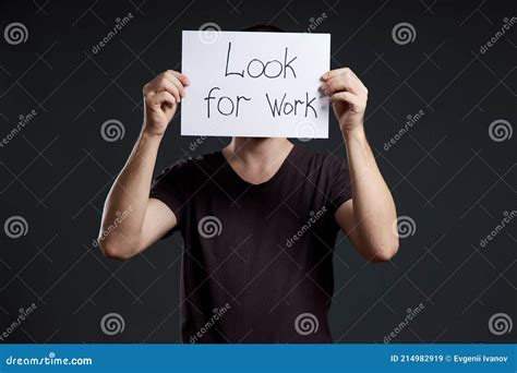 Unemployment And Crisis Man Holds A Sign With The Words Looking For