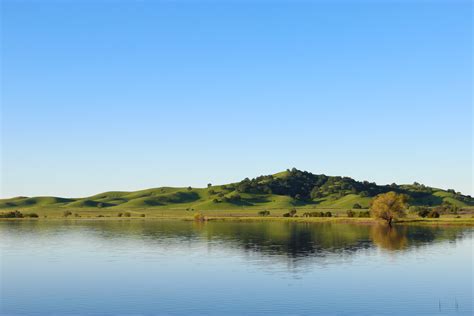 Free Stock Photo Of Hill By Still Lake Under Clear Sky Stock Image