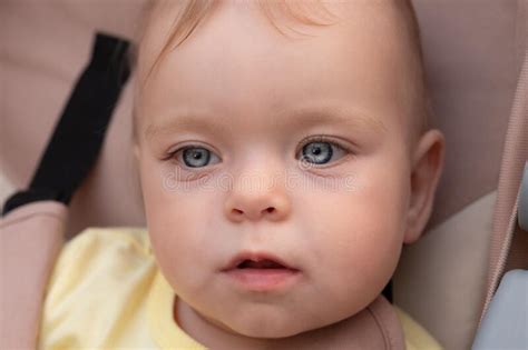 Portrait Of A Baby Baby Girl With Beautiful Gray Eyes Stock Photo