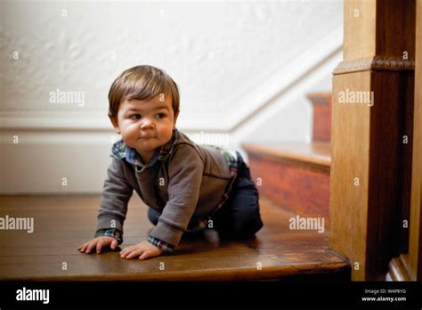 Infant Boy Crawling On The Landing On A Staircase Stock Photo Alamy