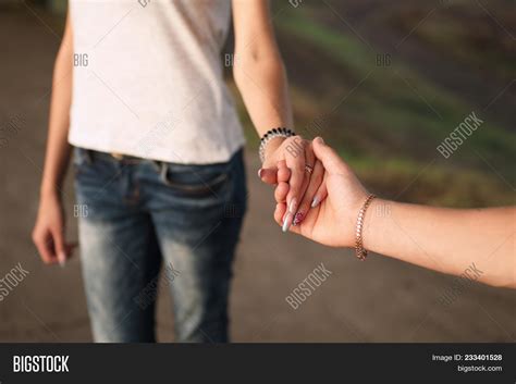 girl and guy holding hands