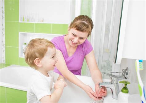 Happy Mother And Child Washing Hands With Soap Together Stock Image