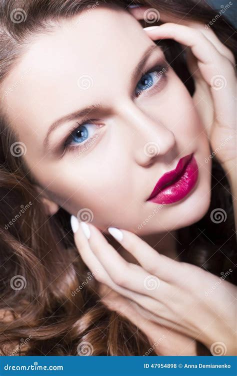 Brunette Woman With Blue Eyes Without Make Up Natural Flawless Skin And Hands Near Her Face