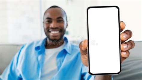 Smiling Black Man Showing Smartphone With Big Blank White Screen At