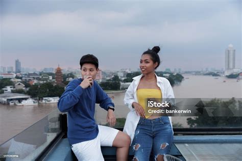 Portrait Asian Lgbt During Sunset On Rooftop And River Background