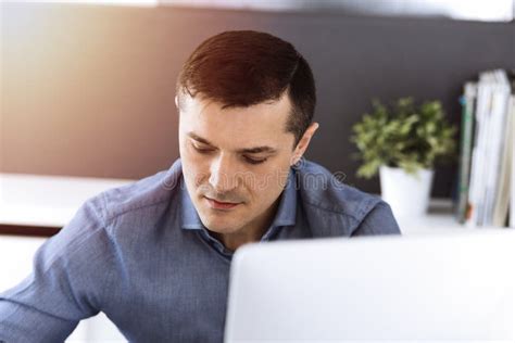 Businessman Working With Computer In Modern Sunny Office Headshot Of