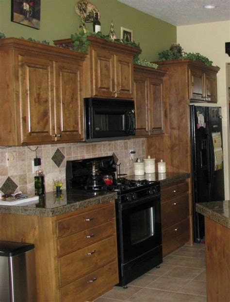 Have you ever thought of the colour sage green? Sage Green Wall Paint, brown wooden kitchen cabinet and ...