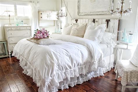 A White Bed Sitting On Top Of A Wooden Floor