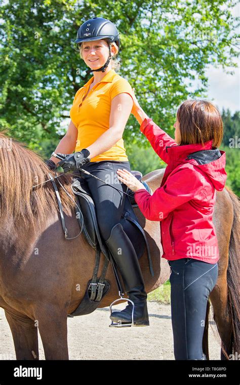 Ic Horse A Riding Instructor Gives A Girl Lessons Hi Res Stock