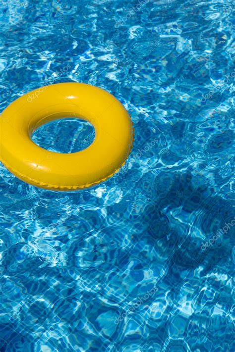 Yellow Pool Float Pool Ring In Deep Cool Blue Refreshing Swimming Pool