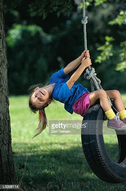 Girl Sitting On A Tire Swing Photos And Premium High Res Pictures